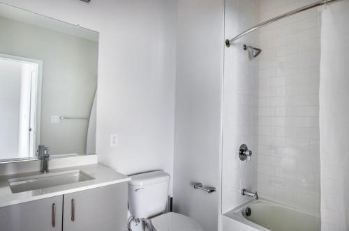 a bathroom with a toilet and a sink and a shower at Brighton 2br w wd gym nr Green Line BOS-894 in Boston