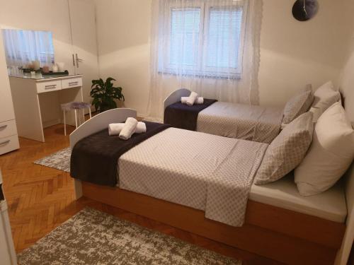 a bedroom with two beds and a window at Holiday Home Matija in Ljubuški