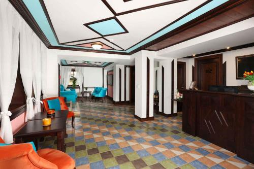 a living room with a coffered ceiling and blue chairs at Armaco Residence in Koprivshtitsa