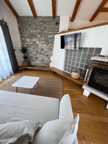 a living room with a couch and a fireplace at Guesthouse 45 in Dutovlje