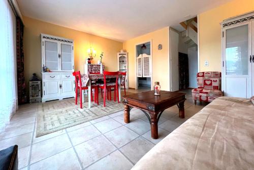 a living room with a table and a dining room at Triplex in Villars Centre with Parking in Villars-sur-Ollon