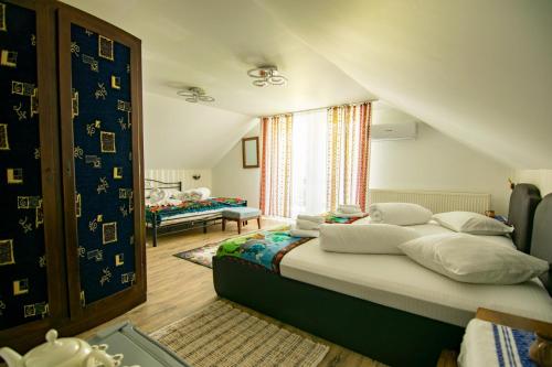 a bedroom with a large bed and a window at Lacrima Izei in Săcel