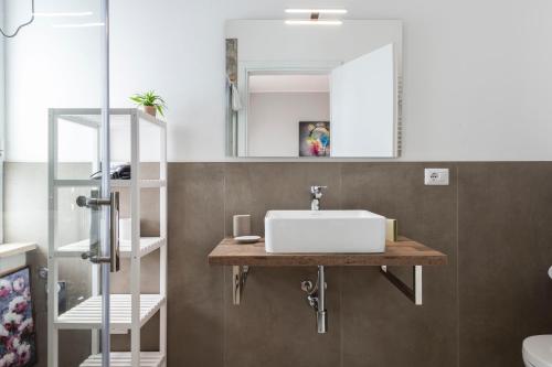 a bathroom with a sink and a mirror at Casa Maglò camere in Verona