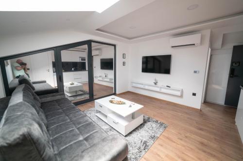 a living room with a couch and a table at Luxury Apartments Una Sarajevo in Sarajevo