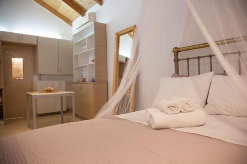 a bedroom with a bed with towels on it at Aurelia Villa Kefalonia in Angón