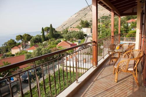 a balcony with chairs and a view of a street at Aurelia Villa Kefalonia in Angón