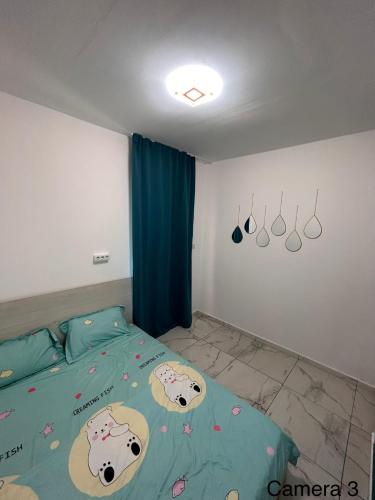 a bedroom with a bed with hello kitty sheets at Locuință privată la mare in Schitul