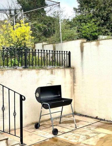 a black chair sitting in front of a fence at Modern and cosy 4 bedroom home in the Mendip Hills, North Somerset in Axbridge