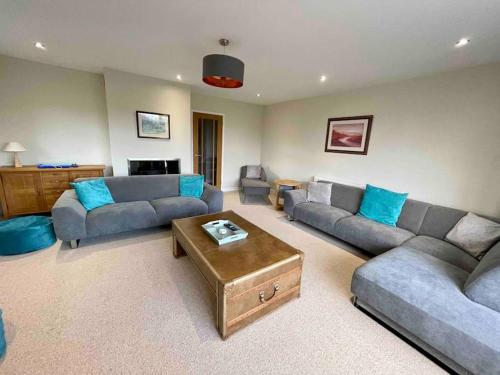 a living room with two couches and a coffee table at Modern and cosy 4 bedroom home in the Mendip Hills, North Somerset in Axbridge