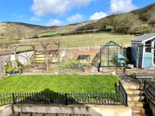 a garden with green grass and a building at Modern and cosy 4 bedroom home in the Mendip Hills, North Somerset in Axbridge