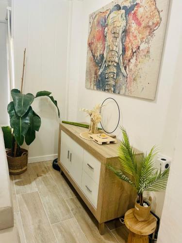a room with a dresser and a painting on the wall at Pontevedra Apartments -New Loft Centro Pontevedra in Pontevedra