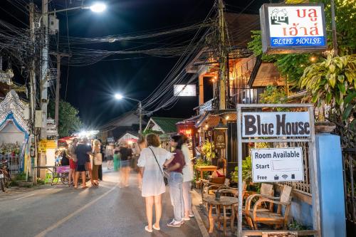 a group of people walking down a street at night at Blue House Pai in Pai