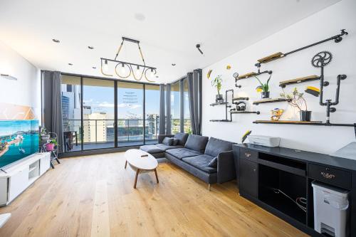 a living room with a couch and a table at Stunning New 2 Bedrooms Apt Shopping & Parking in Sydney