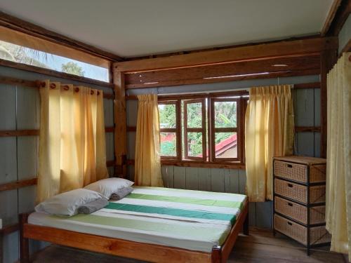 a bedroom with a bed and a window at O'hamok family in Battambang