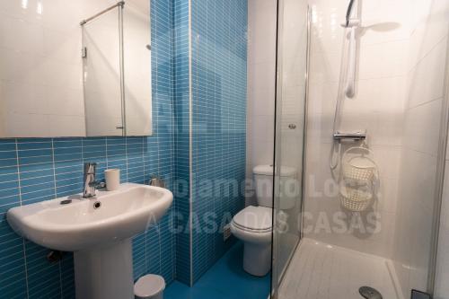 a bathroom with a toilet and a sink and a shower at Home Sweet Home by ACasaDasCasas in Ericeira