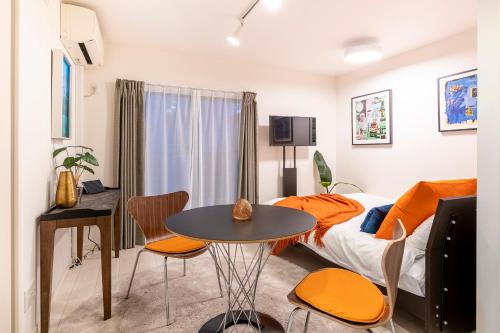a bedroom with a bed and a table and chairs at Blossom Terrace Ryogoku in Tokyo