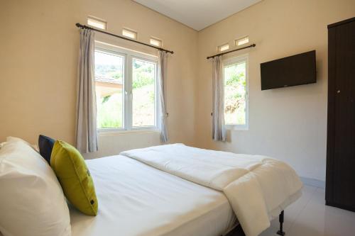 Postel nebo postele na pokoji v ubytování Urbanview Resort Adang Zecky Cisarua Puncak by RedDoorz