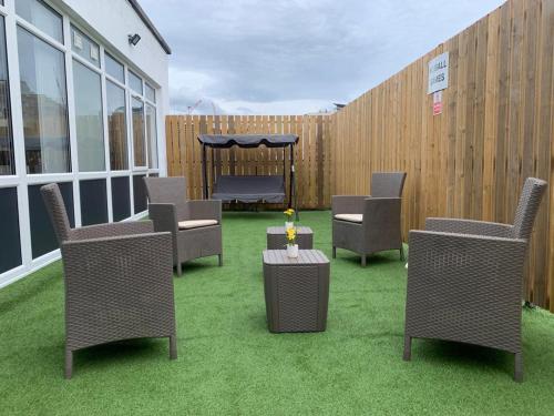 a patio with chairs and a gazebo and a fence at Central Located Apartment in City of London - Farringdon Station in London