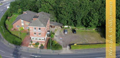 a large house on an island in the middle of a street at Ems-Hotel in Emden