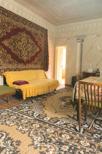 a bedroom with a bed and a large rug at Комната с видом на горы in Dilijan