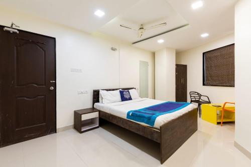 a bedroom with a bed and a black door at Hotel Girgaon Palace Near Chowpatty Beach in Mumbai