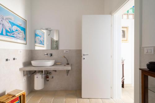 a bathroom with a sink and a mirror at Casa aoom - Casa Vacanze con Sala Yoga e Pilates in San Pietro in Bevagna