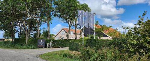 a house and a house with a building at Hof van Renesse in Noordwelle