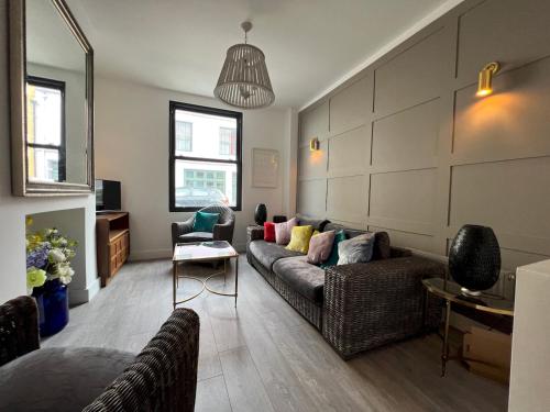 a living room with a couch and chairs at Sea Haven Stylish Beach Oasis - Pass the Keys in Hastings