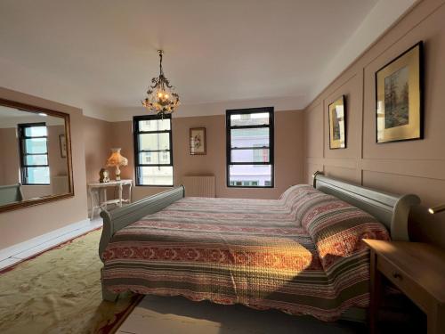 a bedroom with a large bed and windows at Sea Haven Stylish Beach Oasis - Pass the Keys in Hastings