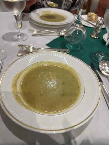 a plate of soup sitting on top of a table at Saxonville Hotel in Whitby