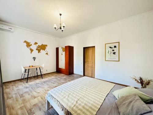 a bedroom with a bed and a table in it at Гостевой дом на Культуры in Kharkiv