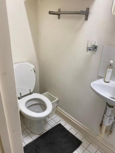 a bathroom with a toilet and a sink at City gem in London