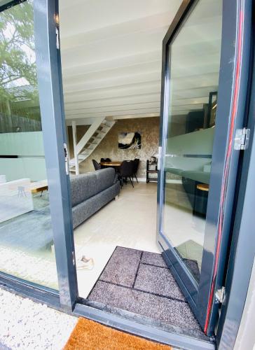 a glass door leading into a living room at Duinzand in Noordwijk aan Zee