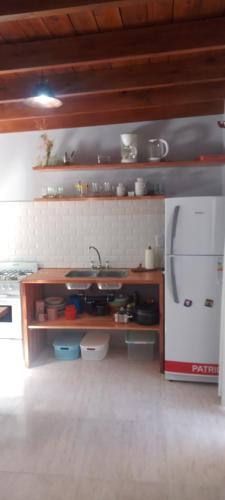 cocina con fregadero y heladera en Lologre en Balneario Mar Azul