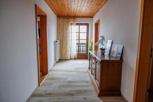 a hallway with a wooden ceiling and a wooden floor at Drexl Gasthof Shiro in Schondorf am Ammersee
