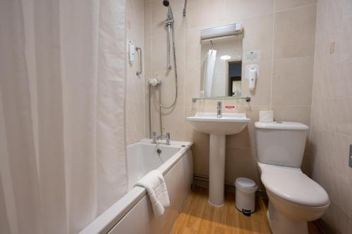 a bathroom with a toilet and a sink and a shower at Millers Hotel by Greene King Inns in Sibson