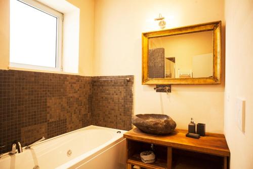 a bathroom with a bath tub and a mirror at Wp Relais apartments in Diso