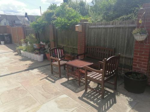 a patio with two chairs and a table and a fence at Big Private Room In Town Centre in Eastleigh