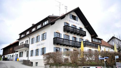 a large white building with balconies on top of it at Drexl Gasthof Shiro in Schondorf am Ammersee
