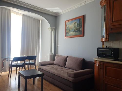 a living room with a couch and a table at Sea View Deluxe in Bat Yam