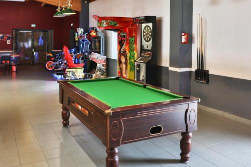 a pool table in a room with avertisement at Camping maeva Club l'Atlantique in Angles