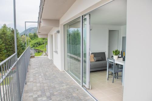 a balcony with a couch and a table at Residence Il Poggio in Dorio