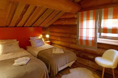 a bedroom with two beds and a chair and a window at Oxygene in Font-Romeu-Odeillo-Via