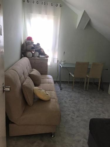 a living room with a couch and a table at Givat Zeev - between Jerusalem and Tel Aviv, 25 minutes from the airport in Giv'at Ze'ev
