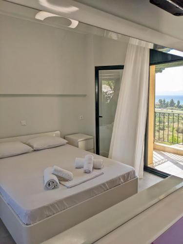 a bedroom with a bed with towels on it at Spacious Holiday House with Shared Pool in Hanioti
