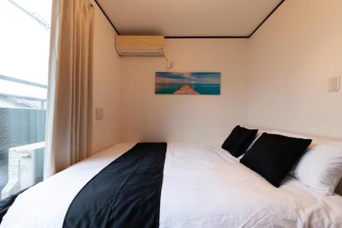 a bedroom with a bed in a room with a window at City center Shibuya -都心縁渋谷- in Tokyo