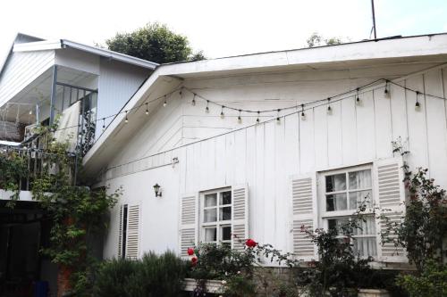 a white house with christmas lights on it at Maily homestay in Ấp Trạm Hành