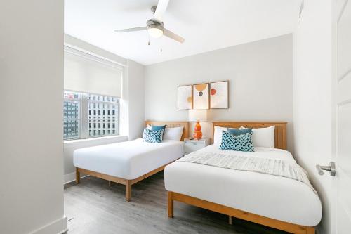 a bedroom with two beds and a window at Luxury 4B Condo Newly Renovated Steps to French Quarter in New Orleans