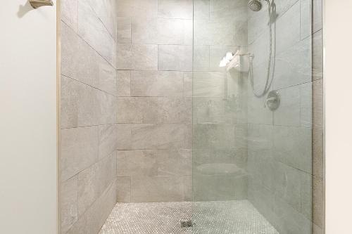 a bathroom with a shower with a glass door at Luxury 4B Condo Newly Renovated Steps to French Quarter in New Orleans