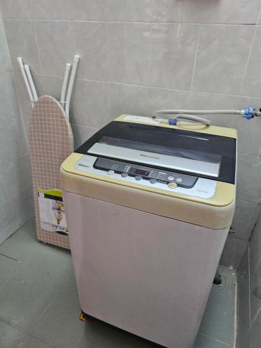 a small appliance sitting in a corner of a room at Sapphire Residence in Jenjarum